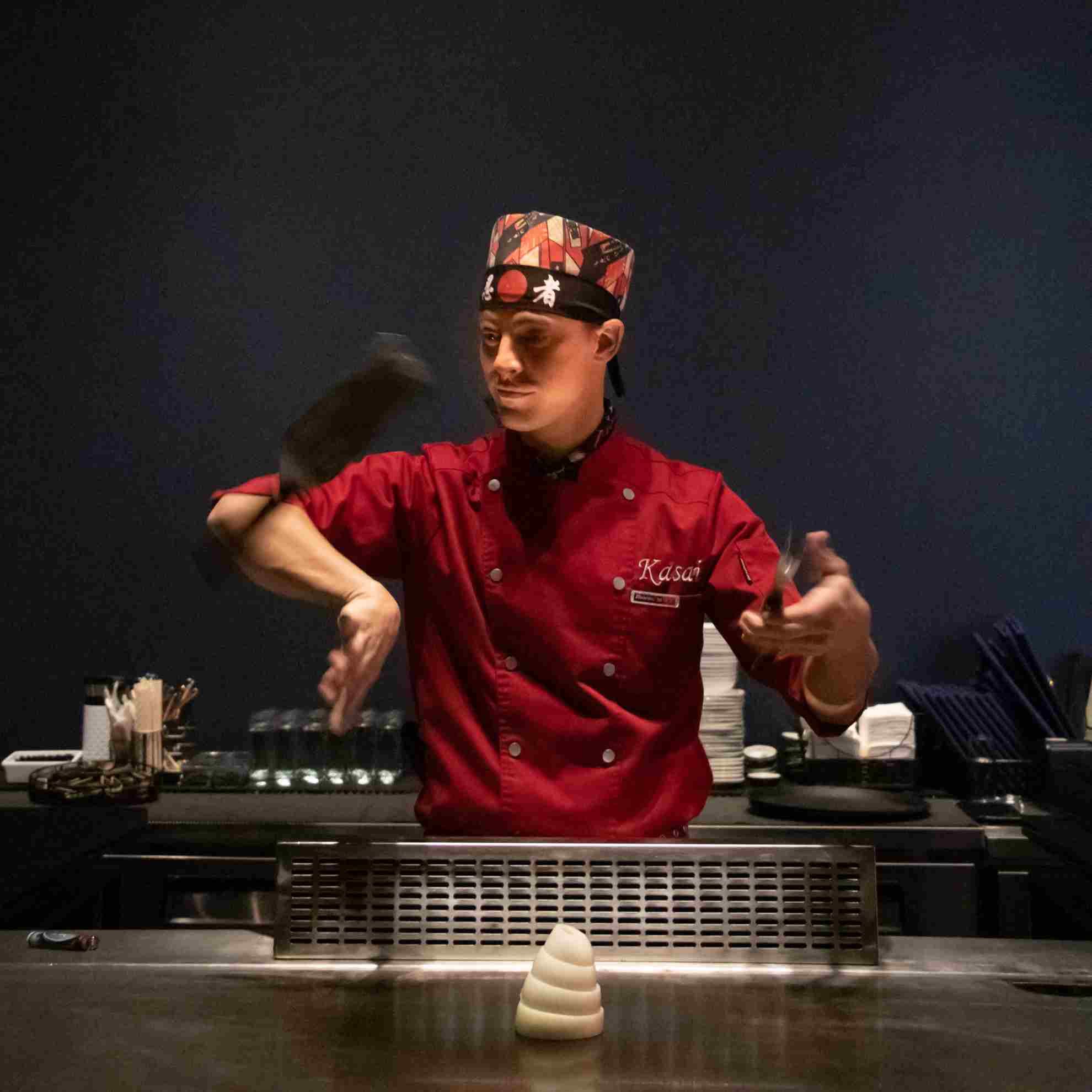 A Kasai chef flipping utensils mid-performance